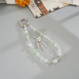 Close-up of beaded phone strap with clear and green crystals and butterfly pendant