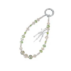 Detailed view of handmade beaded phone strap with iridescent beads and butterfly charm