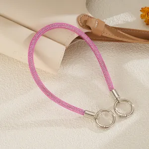 Detail view of pink rhinestone mesh rope phone strap with silver ring buckles