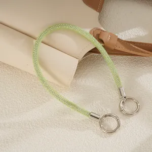 Detail view of luxury mint green rhinestone mesh rope phone strap with silver double clasps.
