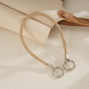 Close-up of sparkling champagne gold rhinestone mesh phone wrist strap with double clasps.