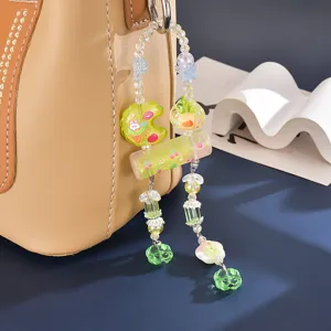 Macro detail of candy-colored beaded bag charm with cute ice cream prints