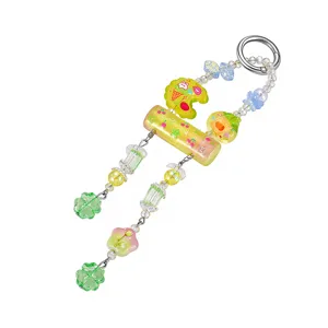 Detailed view of candy-colored beaded keychain with clover and floral charms