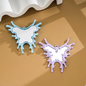 Detailed close-up of butterfly mirror pendants with irregular liquid edges for DIY decor