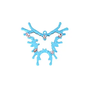 Close-up detail of a blue irregular dripping butterfly pendant adorned with pink gemstones