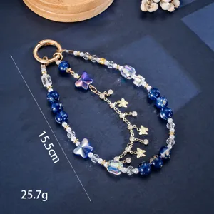 Detailed view of the blue gold foil bead phone strap with butterfly pendant