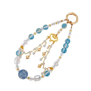 Detailed view of blue gold foil beads and gold heart charms on a phone strap