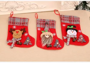 Détail de chaussette de Noël avec trois sacs cadeaux en peluche écossaise et personnages.