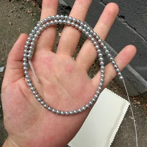 Macro view of 4mm round grey freshwater pearl strand for handmade DIY jewelry making projects