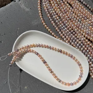 Detail view of 6-6.5mm candy-colored freshwater pearls with high luster on a white plate