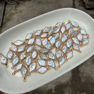 Detailed view of rhombus baroque freshwater pearls with gold-plated copper edges