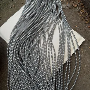 Macro detail showing multiple strands of 4mm grey near-round freshwater pearl beads.