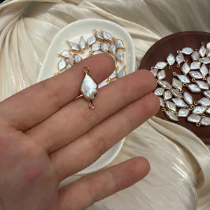 Close-up of a rhombus Baroque pearl connector with gold-plated edging for DIY jewelry