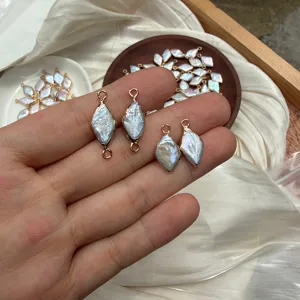 Close-up of rhombus baroque pearl charms with gold-plated edges for DIY jewelry making