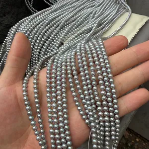 Close-up of 4mm near-round grey freshwater pearls strands for DIY jewelry making.