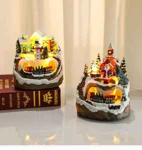 Christmas resin musical ornament snow village scene with rotating train and LED warm lights.