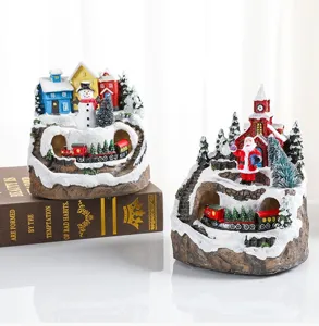 Detailed view of Christmas resin musical ornament featuring rotating train and snow scene.