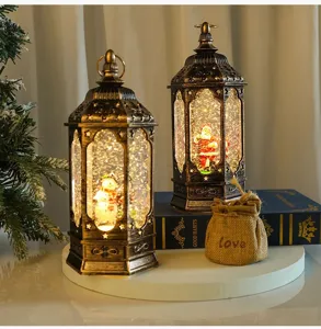 Christmas glitter water snow globe lantern with music and lights, festive holiday decor detail.