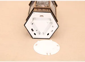 Detailed view of Christmas decorative water lantern battery compartment and white cover.