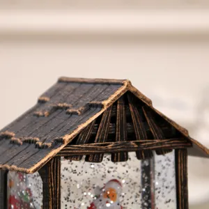 Close-up detail of the retro Christmas cabin snow globe roof, featuring delicate vintage texture.