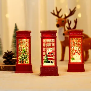 Christmas telephone booth snow globe night light detail with warm glowing festive decor.