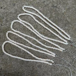 Macro view of high-quality natural white rondelle pearl strands showing texture and luster