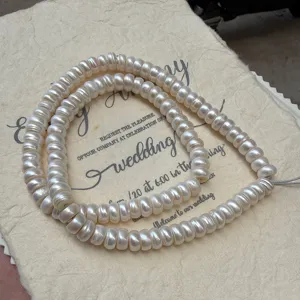 Macro view of 108 high-luster natural white beads pearls in Tibetan style for jewelry