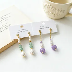 Exquisite detail shot of freshwater pearl and green jade Chinese style drop earrings.