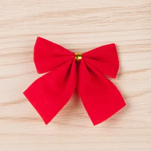 Close-up of red velvet Christmas bow decoration detail, festive holiday craft tree accessory.