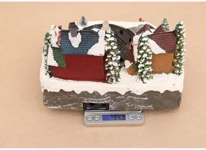 Christmas village resin musical box snow scene desktop decoration detail view showing weight