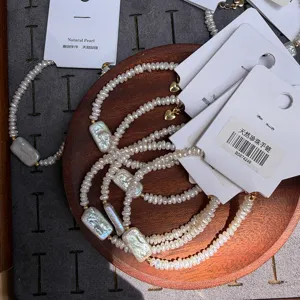 Detail of Baroque pearl bracelets with unique gum square shaped pearls on a wooden display