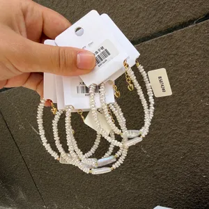 Close-up of irregular baroque pearl bracelets with adjustable gold chain and heart charm