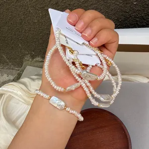 Close-up of irregular square baroque pearl bracelet with adjustable gold chain on wrist