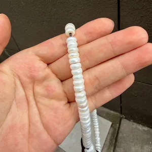 Close-up detail of white flat round cut freshwater pearl beads DIY semi-finished item