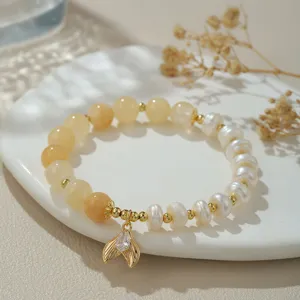 Detailansicht der natürlichen Perlen und gelben Kristall Perlenarmband mit Fischschwanz Anhänger.