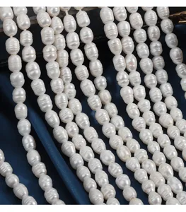 Detailed view of natural freshwater rice pearl strands featuring unique deep threaded texture.