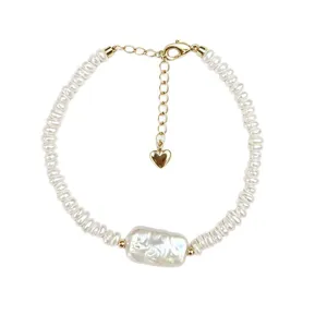 Elegant baroque pearl bracelet with a large central gum-shaped pearl and gold heart charm