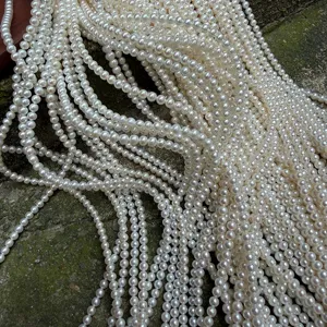 Gedetailleerde close-up van meerstrengse witte zoetwaterparels met gladde glans en textuur.
