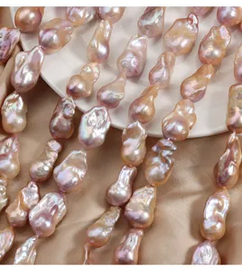 Stunning natural freshwater baroque pearl strands with vibrant pink luster and unique fish-tail shapes.