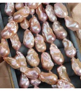 Natural freshwater baroque pearl strand with pink iridescent luster for elegant DIY jewelry making.