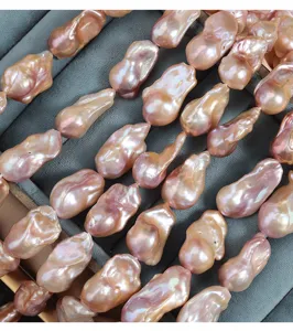 Close up of large baroque freshwater pearls fish tail shape strong luster pink jewelry detail