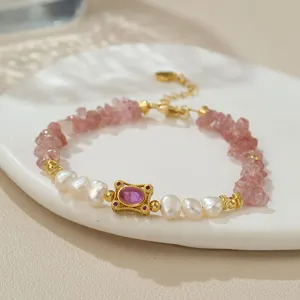Nahaufnahme des Süßwasserperlen und Erdbeerquarz Perlenarmbands mit goldenen Akzenten.