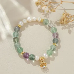 Nahaufnahme Detail der chinesischen Süßwasserperle und bunten Kristall Perlenarmband mit Glocke.