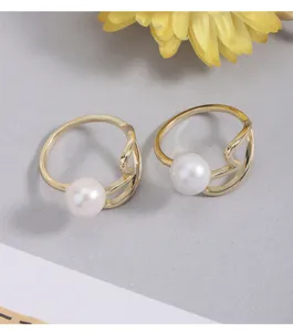 Detailansicht des eleganten vergoldeten offenen Perlenrings mit wellenförmigen Linien und Perle.