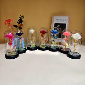 Detail shot of colorful gold foil rose glass dome gifts with LED lights, colorful tabletop decor.