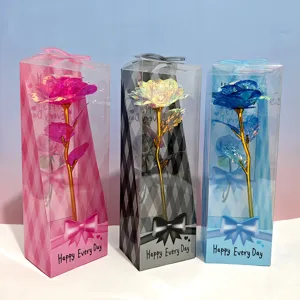 Colorful gold foil artificial rose flower in a triangular gift box for romantic occasions.