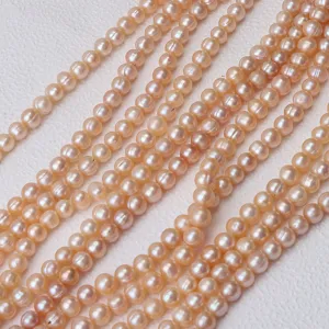 Fili sciolti di perle d'acqua dolce naturali, perle rosa quasi tonde per la gioielleria.