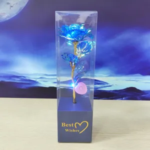 Colorful gold foil artificial rose flower with LED string lights in clear gift box detail view.