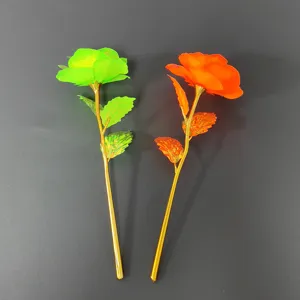 Close-up detail shot of golden foil artificial roses, showing vibrant dual-color flower heads.
