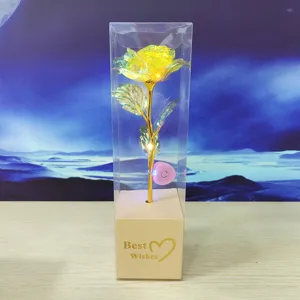 Gold foil rose flower gift in clear transparent box with LED lights for romantic occasions.